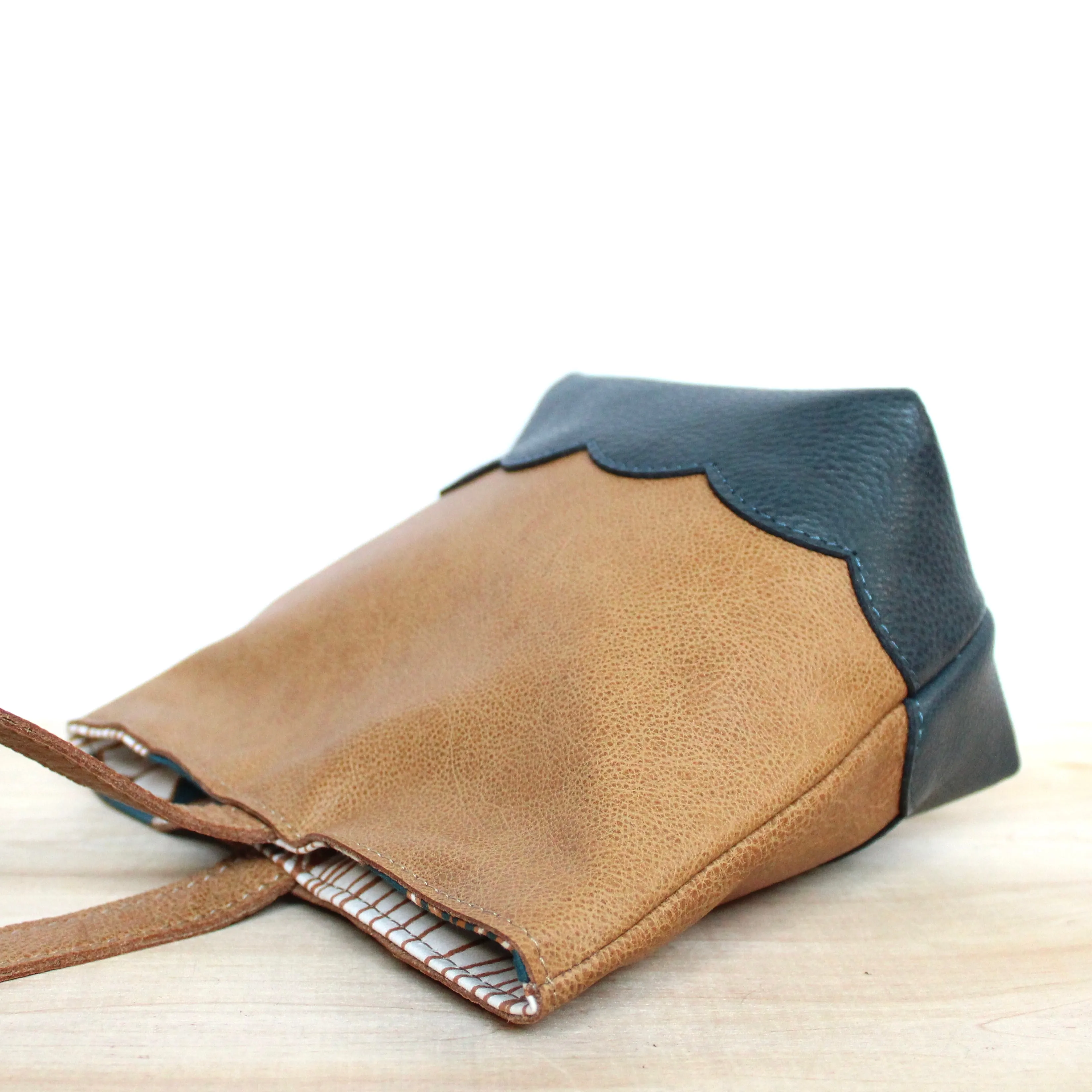 scalloped wristlet: buff tan/pebbled dark stone blue
