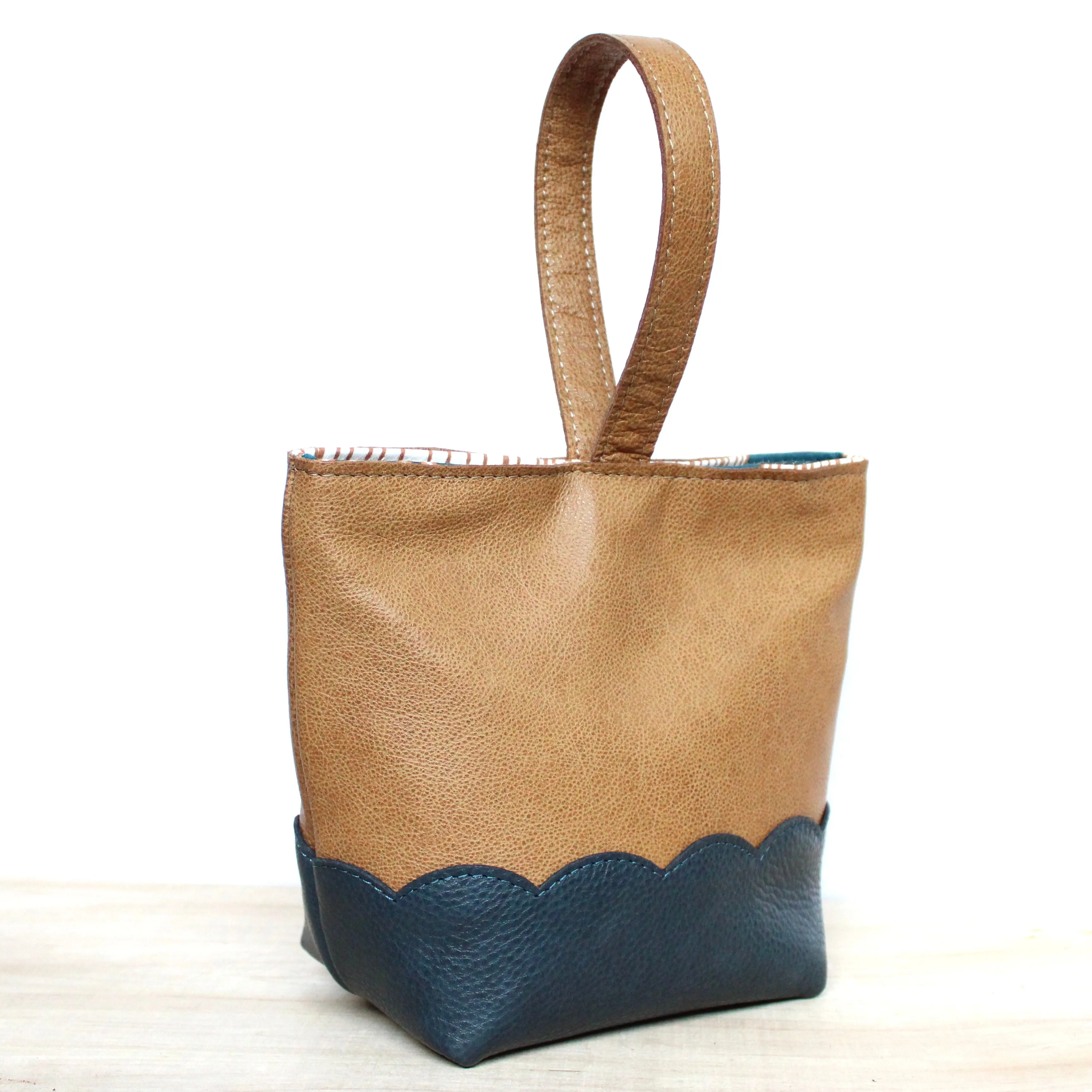 scalloped wristlet: buff tan/pebbled dark stone blue